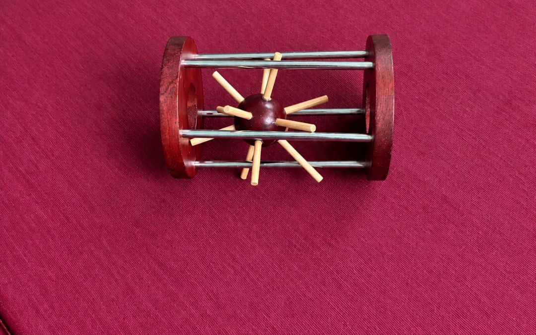 Rompecabezas de madera en forma de barril con varillas y una esfera central